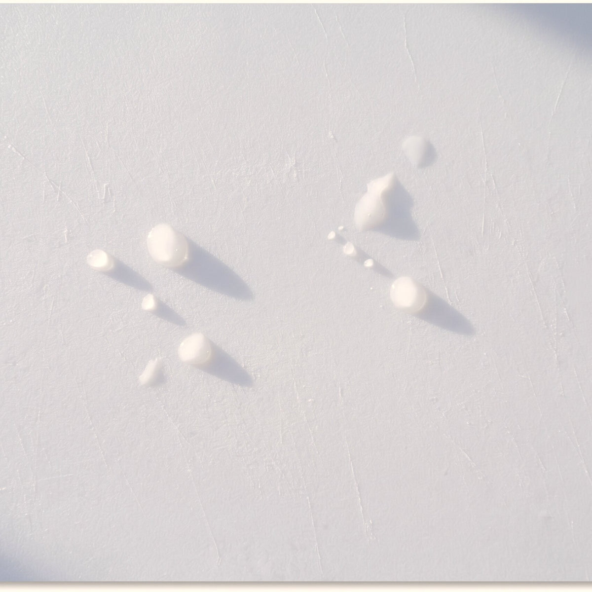 A close view of a washed CleanCut sheet, water droplets beading on the surface in low raking light.