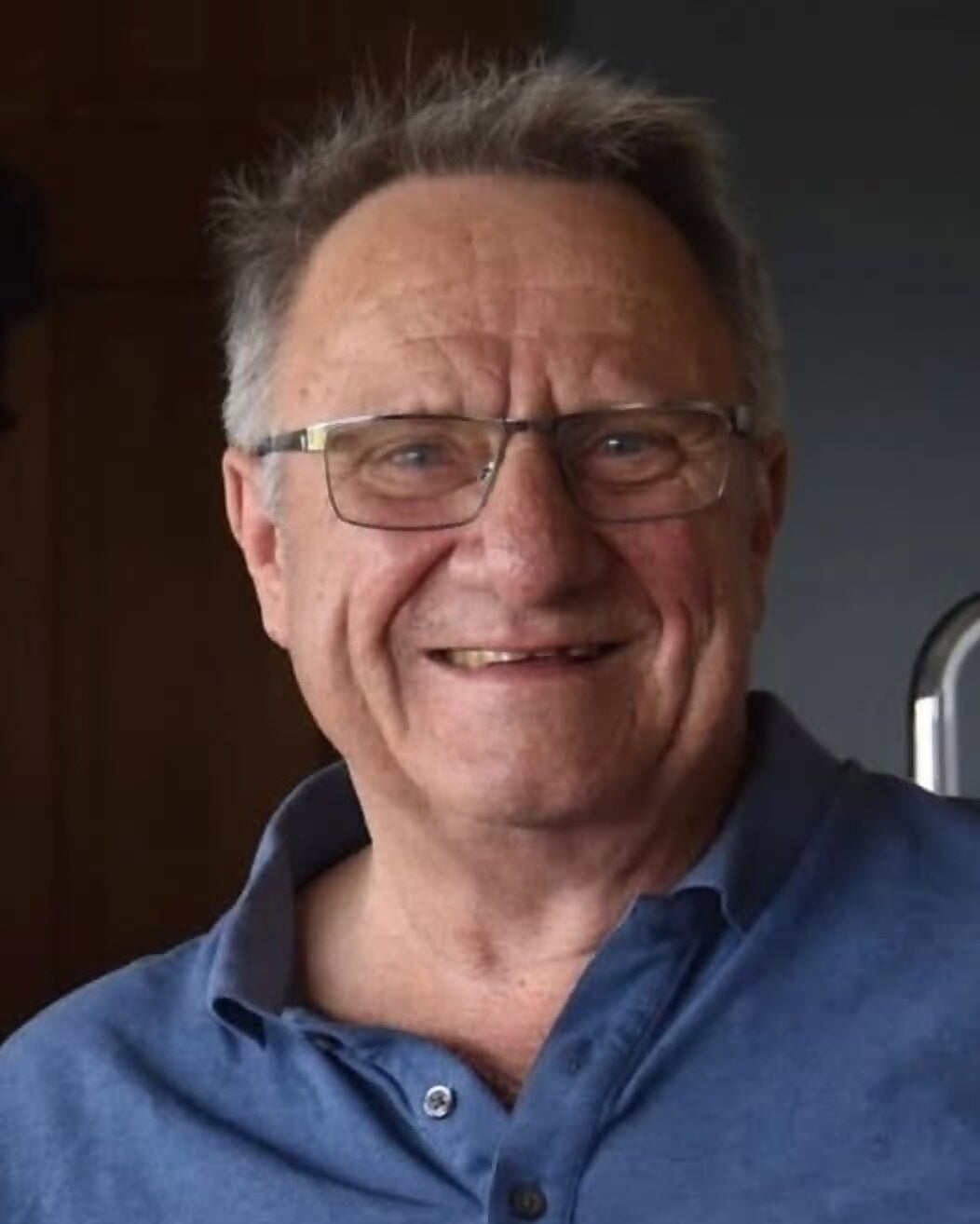 Dennis Arsenault, who founded CleanCut, smiling in a blue polo shirt at home.